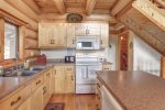 Dakota log Cabin kitchen with full log interior. 